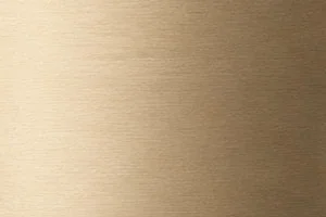 Close-up of a brushed gold metal texture with fine horizontal grain lines, showcasing a sleek metallic surface.