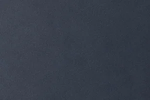 A close-up view of a textured dark gray surface, evenly shaded.
