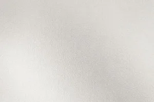 A light neutral background with a subtle textured surface, ideal for design and decorative uses.