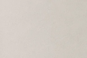A simple beige textured surface used as a neutral background.